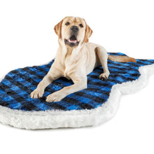 A Labrador retriever laying on a furry curved dog bed with blue and black checkered pattern 