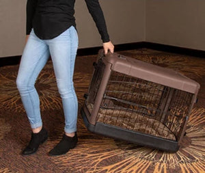 a woman dragging a chocolate colored steel dog crate on the floor with modern design