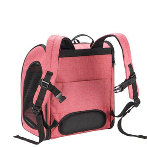 a back view of a pink dog carrier showing its back pack straps 