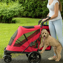 a woman getting her dog inside a candy red dog stroller in the park