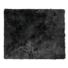 a full laid out balck furry dog blanket 