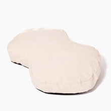 a cream colored dog bed wit white background