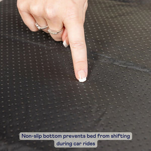 a close up image of a woman's finger pointing at a black non slip surface