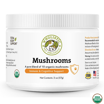 A white plastic jar of "WHOLISTIC PET ORGANICS MUSHROOMS," a dietary supplement for pets. The label highlights "Immune & Cognitive Support" and states it's "A pure blend of 10 organic mushrooms." The jar has a green USDA Organic seal and a quality seal from NASC. The product contains 2 oz (57g).