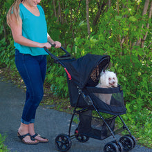 a woman walking her dog in the park in a black dog stroller with jaguar inseert
