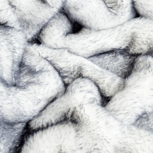 a close up image of a white and grey fluffy fabric of a dog blanket 