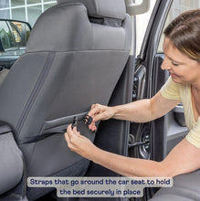 a woman fixing a seat belt at the back of a car's passenger seat