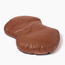 a brown leather dog bed 