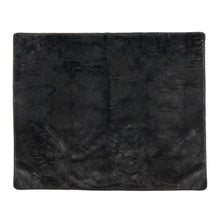 a laid out black furry dog blanket
