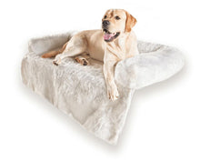 a labrador retriever laying on a white dog couch lounger in white background