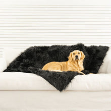 a golden retriever laying on a black furry dog blanket on top of a white couch in an all white living room setting 