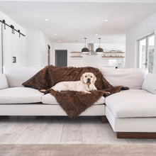 a labrador retriever laying on a brown furry dog blanket on a white L shaped couch in an all white dinning/living room setting 