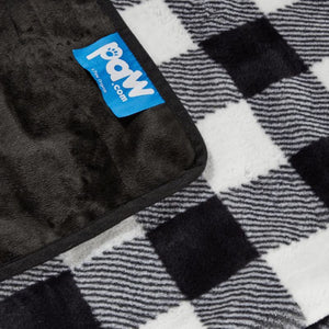 close up image of a of the fabric of a black and white checkered pattern dog blanket with blue tag of paw.com
