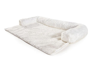 a white fluffy dog couch lounger in white background