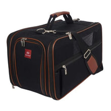 a full view image of a balck and brown dog carrier with shoulder strap and brown accents