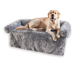 a labradr retriever laying on a grey couch lounger with white background