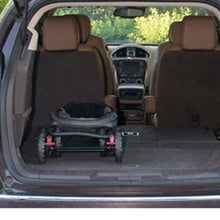 a folded stroller at the back of a white car