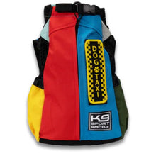 a front image of a multi colored dog backpack in red, blue, yellow and green on side pockets 
