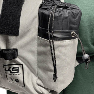 close up image of a white dog backpack carrier with a bag of inflatable dog bed on its side pockets 