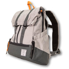 Semi side view image of a grey dog backpack carrier with side pockets and backpack straps 