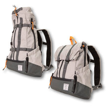 A pair of a heavy duty dog backpack carrier with side pockets facing left  , one fully extended and the other is not 