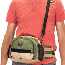 a man wearing on orange shirt and a green shoulder and hip bag