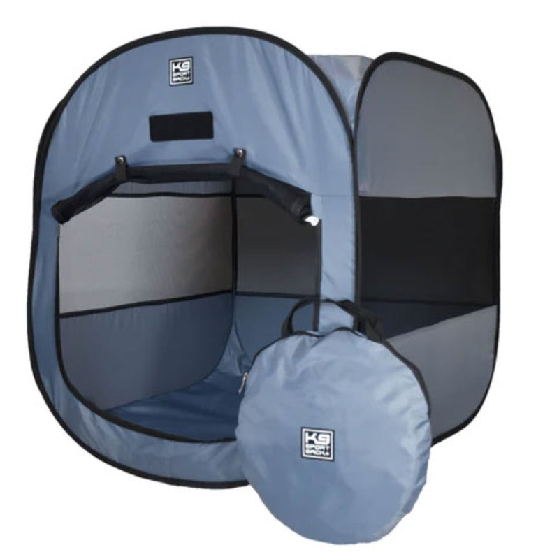 a blue pop up tent for dog with its front door open next to a round bag