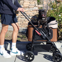 a man pushing his don inside a brown dog stroller on the sidewalk 