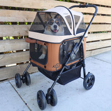 a dog inside a brown dog carrier/stroller with organizer at the bottom parked next to a wooden fence