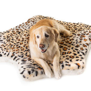 A Golden retriever laying on a soft furry curved dog bed with cheetah pattern