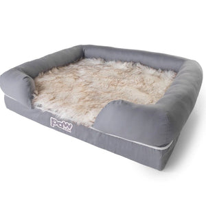 A rectagular gray memory foam bolster and trooper dog bed with dirty white fur and brown accents