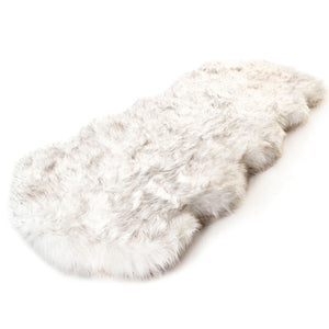 A full view of a furry curve white orthopedic dog bed 