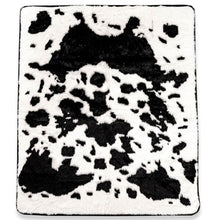 A top view of a waterproof black cowhide patterned dog blanket