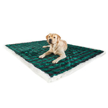 A labrador retrievier laying on a black and green checkered pattern waterproof dog blanket 