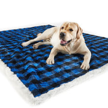 A labrador retriever laying on top of a waterproof black and blue checkered pattern dog blanket 