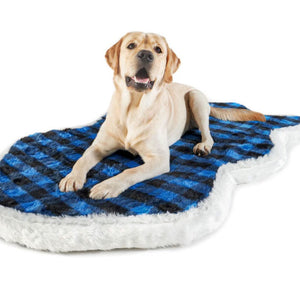 A Labrador retriever laying on a furry curved dog bed with blue and black checkered pattern 