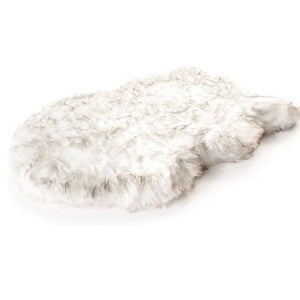 A furry white orthopedic dog bed with brown accents 
