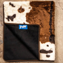 A brown cowhide patterned waterproof dog blanket almost folded in half showing a logo of paw.com in black background 