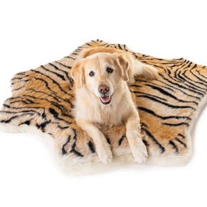 A golden retriever laying on a curved soft furry tiger printed orthopedic  dog bed