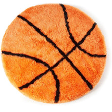 A top view of furry basketball shaped orange dog bed