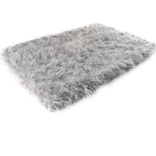 A rectangular furry grey orthopedic dog bed 