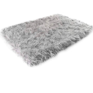 A rectangular furry grey orthopedic dog bed 