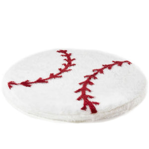 A furry round white baseball shaped dog bed