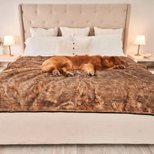 a golden retriever sleeping on a brown dog blanket on top of a white bed in a modern bedroom