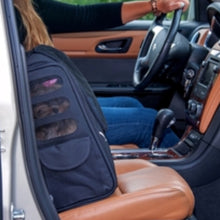 a close up image of a shih-tzu inside a 5-in-1 Pet Carrier [Backpack/Tote/Roller Bag/Carrier/Car Seat] inside a car with leather seats next to a driving lady in black