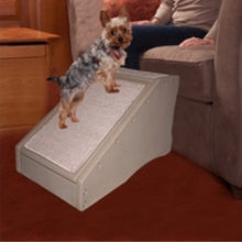 a close up image of a yorkie standing on a Pet Gear Step / Ramp Combination with supertraX, Tan next to a lady siting on a brown couch 