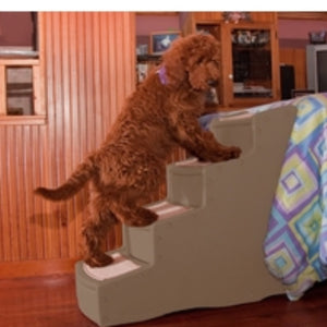A toy poodle getting on bed through a four step dog stair in tan color in a modern bedroom