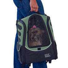 a woman carrying her dog inside a sage dog carrier