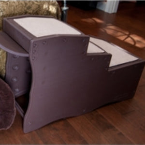 A close up image of Pet Gear Easy Step Bed Stair, Chocolate next to a bed in a wooden floor