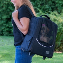 a lady carrying her dog on her shoulder through a 5-in-1 Pet Carrier [Backpack/Tote/Roller Bag/Carrier/Car Seat]